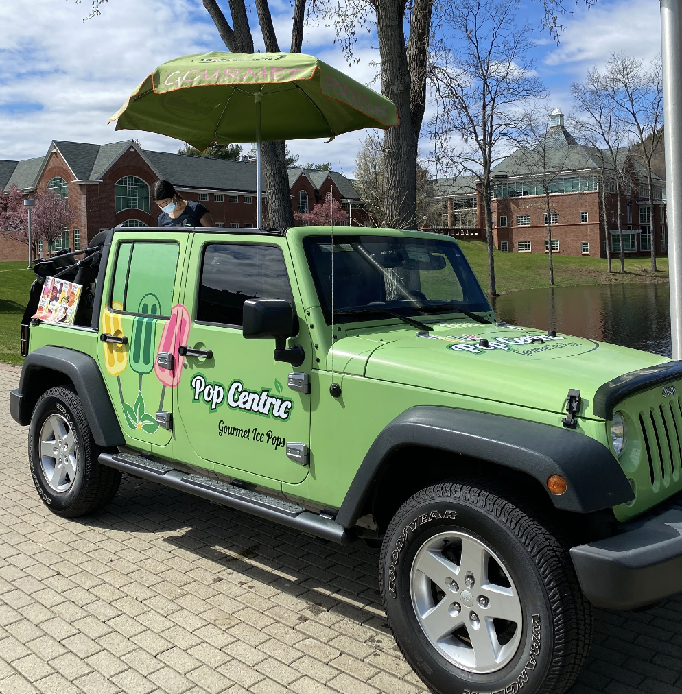 Green Pop Centric Gourmet Ice Pops Jeep parked on campus with umbrella