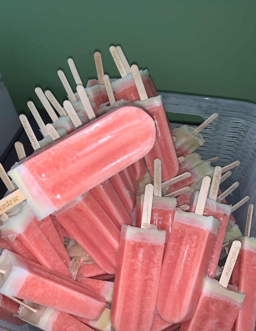 Tray of watermelon-style PopCentric ice pops with branded wooden sticks